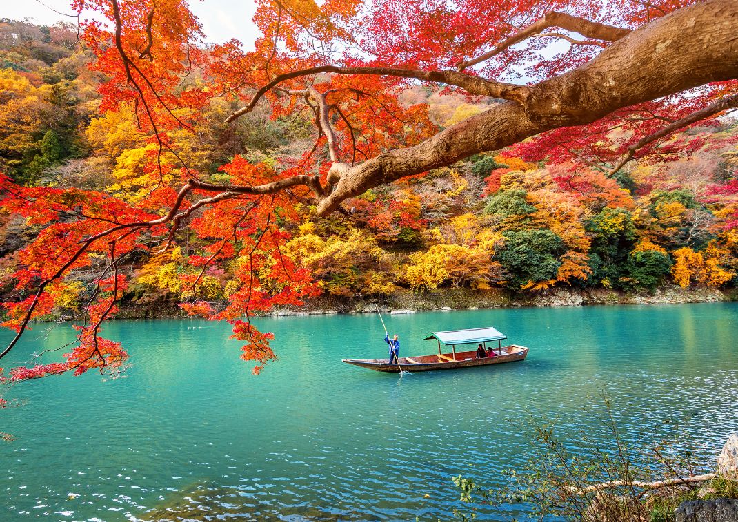 Boat on Katsura River in autumn in Kyoto, Japan