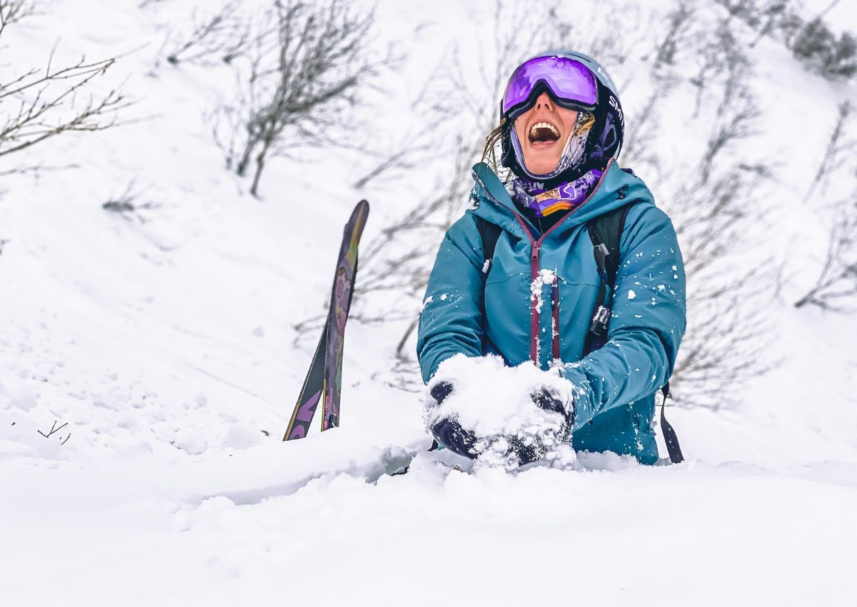 Kvinna som njuter av snön i Japan