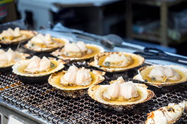 Grillade pilgrimsmusslor på morgonmarknaden, Hakodate